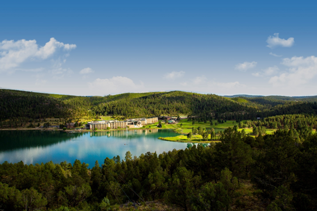 Wooded hills and smooth lake surrounding the Inn of the Mountain Gods Resort & Casino